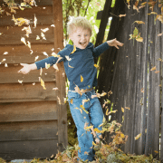 Boy playing with autumn leaves because play is making a comeback. Photo credit: Justin Young