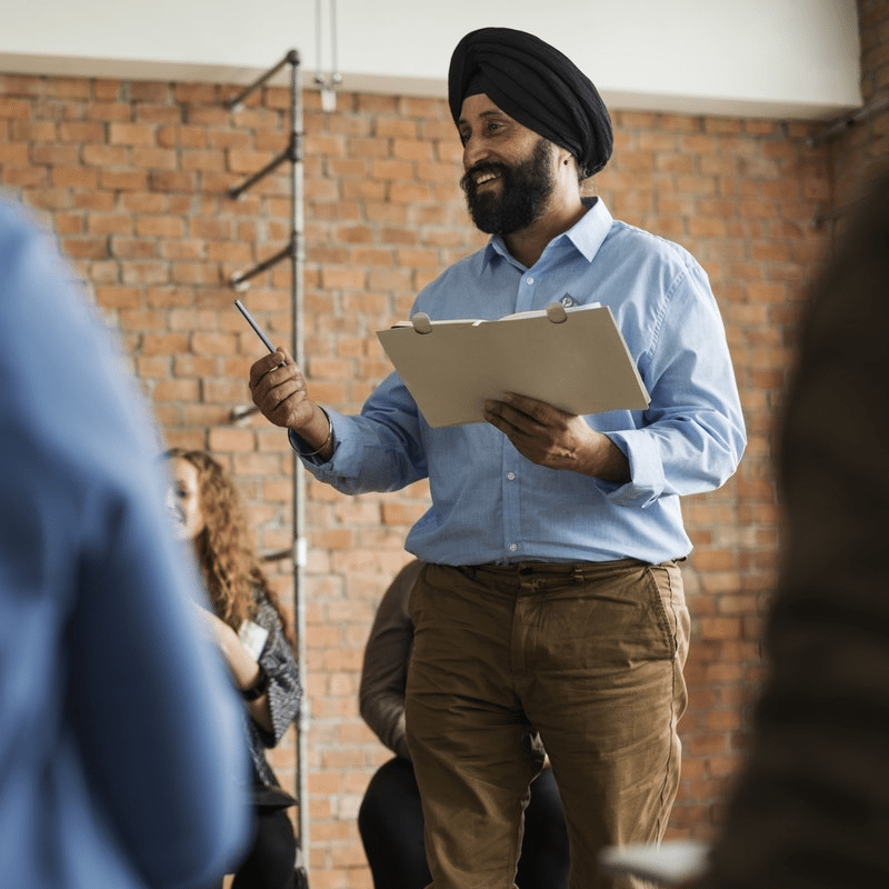 Man using his most potent tool, his language to lead a group.