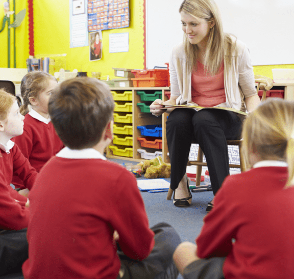 teacher speaking to students coming back to school